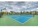 Outdoor tennis and basketball courts on a clear day with modern blue and green surfacing, surrounded by landscaping at 6113 Plover Meadow St, Lithia, FL 33547