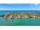 Expansive aerial view showcasing a condo community with a scenic waterfront, golf course, and cityscape at 6268 Palma Del Mar S Blvd # 113, St Petersburg, FL 33715
