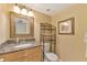 Bathroom features a granite vanity, framed mirror, and decorative shelving adding style and functionality to the space at 6268 Palma Del Mar S Blvd # 113, St Petersburg, FL 33715