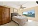 Bright bedroom with a large window offering beautiful views of the ocean and palm trees at 6268 Palma Del Mar S Blvd # 113, St Petersburg, FL 33715
