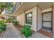 Exterior view of unit 113 featuring a neutral color scheme, an inviting entrance and manicured landscaping at 6268 Palma Del Mar S Blvd # 113, St Petersburg, FL 33715