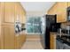 The kitchen features sleek stainless steel appliances and ample storage space with bright wooden cabinetry at 6268 Palma Del Mar S Blvd # 113, St Petersburg, FL 33715