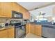A modern kitchen with granite countertops, stainless steel appliances, and bright wooden cabinetry at 6268 Palma Del Mar S Blvd # 113, St Petersburg, FL 33715
