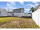 Spacious backyard enclosed by a white fence, features a deck and two-story home with gray siding at 628 47Th W St, Palmetto, FL 34221