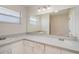 Bright bathroom with a large mirror, white cabinets, and double sinks at 628 47Th W St, Palmetto, FL 34221