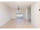 Well-lit dining room with tile flooring, sliding glass doors, and a stylish chandelier at 628 47Th W St, Palmetto, FL 34221