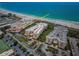 Stunning aerial view of beachfront condos, showcasing the pristine beach and turquoise ocean waters at 6500 Sunset Way # 501, St Pete Beach, FL 33706