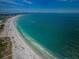 Breathtaking aerial view showcasing the pristine beach and turquoise waters at 6500 Sunset Way # 501, St Pete Beach, FL 33706