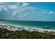 Expansive beach with clear blue waters, white sand, and beachgoers enjoying the sunny day at 6500 Sunset Way # 501, St Pete Beach, FL 33706