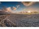 A wide sandy beach with scattered people and wheel tracks in the sand at 6500 Sunset Way # 501, St Pete Beach, FL 33706