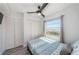 Bright bedroom with a window view, ceiling fan, and closet space at 6500 Sunset Way # 501, St Pete Beach, FL 33706