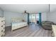 Comfortable bedroom with stylish furnishings, ceiling fan, and balcony access through sliding glass doors at 6500 Sunset Way # 501, St Pete Beach, FL 33706