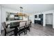 Inviting dining room boasts modern light fixture, stylish seating, and wet bar adjacent to the kitchen at 6500 Sunset Way # 501, St Pete Beach, FL 33706