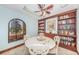 Cozy dining room featuring a round table, built-in bookshelves, and a charming window view at 6500 Sunset Way # 501, St Pete Beach, FL 33706