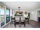 Open dining room with views, an elegant table set and stylish lighting near a modern kitchen at 6500 Sunset Way # 501, St Pete Beach, FL 33706