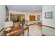 Well-lit lobby area with a decorative desk, potted plants, and mailboxes at 6500 Sunset Way # 501, St Pete Beach, FL 33706