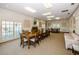 Large meeting room with a long wooden table, chairs, a fireplace, and shuttered windows at 6500 Sunset Way # 501, St Pete Beach, FL 33706