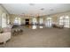 Spacious meeting room with chandeliers, a fireplace, ample seating, and large arched windows providing natural light at 6500 Sunset Way # 501, St Pete Beach, FL 33706