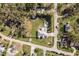 An aerial view of the property, showcasing the pool, fenced yard and mature trees surrounding the home at 6705 Myrna Dr, Tampa, FL 33619