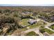 Aerial view of the property shows the extensive lot, pool, and mature trees in the surrounding landscape at 6705 Myrna Dr, Tampa, FL 33619