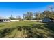Spacious backyard with a large grassy area and view of a large utility shed at 6705 Myrna Dr, Tampa, FL 33619