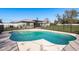 Inviting kidney-shaped pool surrounded by a secure fence and spacious deck at 6705 Myrna Dr, Tampa, FL 33619