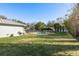 Backyard view of in-ground pool, shed, and lush landscaping at 6705 Myrna Dr, Tampa, FL 33619