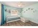 Light green bedroom featuring wood floors, twin bed and crib at 6705 Myrna Dr, Tampa, FL 33619
