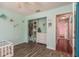 Light green bedroom features wood floors, and closet with drawer storage at 6705 Myrna Dr, Tampa, FL 33619