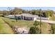 Aerial front elevation showcasing a modern home with a well-manicured lawn and long driveway at 6705 Myrna Dr, Tampa, FL 33619