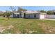 Well-maintained front lawn with a palm tree and an attractive grey home at 6705 Myrna Dr, Tampa, FL 33619