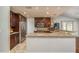 Bright kitchen featuring a modern stainless steel refrigerator and granite countertops at 6705 Myrna Dr, Tampa, FL 33619