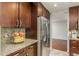 Close-up view of kitchen showcasing stainless steel refrigerator and granite counter at 6705 Myrna Dr, Tampa, FL 33619