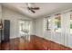 Bright living room featuring hardwood floors, large windows with natural light, and access to a sunroom at 6705 Myrna Dr, Tampa, FL 33619