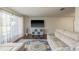 Modern living room setup with hardwood floors, a sectional sofa, and a sleek entertainment center at 6705 Myrna Dr, Tampa, FL 33619