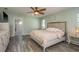 Serene bedroom features wood-look floors and adjoins a bright, well-appointed en-suite bathroom at 6705 Myrna Dr, Tampa, FL 33619