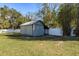 Backyard view of property featuring an outbuilding shed surrounded by a well-maintained lawn at 6705 Myrna Dr, Tampa, FL 33619