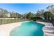 In-ground pool surrounded by lush landscaping, perfect for relaxing and entertaining at 6705 Myrna Dr, Tampa, FL 33619