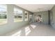 The sunroom features tile floors, natural light, and sliding glass doors at 6705 Myrna Dr, Tampa, FL 33619