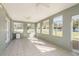 Bright sunroom features tile floors, a ceiling fan, and views of the spacious backyard at 6705 Myrna Dr, Tampa, FL 33619