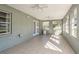 Sunroom with tile floors, natural light, and multiple windows at 6705 Myrna Dr, Tampa, FL 33619