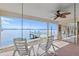 Relaxing covered patio with swing and chairs overlooking the serene waterfront and private boat dock at 672 Boca Ciega Point N Blvd, St Petersburg, FL 33708