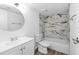 Bathroom features a white vanity and a tub with patterned marble tile at 711 Russell Ln # 238, Brandon, FL 33510
