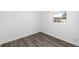 Small bedroom with a window and neutral walls and gray wood flooring at 711 Russell Ln # 238, Brandon, FL 33510