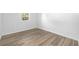 Bright bedroom with a large window, neutral walls, and wood-look flooring at 711 Russell Ln # 238, Brandon, FL 33510