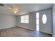 Bright and airy living room featuring modern gray walls, stylish plank flooring, and ample natural light at 7234 Castanea Dr, Port Richey, FL 34668