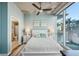 Serene bedroom with a king bed, light blue walls, and a large window with city views and balcony access at 777 N Ashley Dr # 915, Tampa, FL 33602