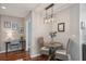 Dining area featuring a round wooden table, wicker chairs, and stylish decor next to small office nook at 777 N Ashley Dr # 915, Tampa, FL 33602