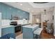 Modern kitchen boasts sleek blue cabinets, stainless steel appliances, and a functional island with bar seating at 777 N Ashley Dr # 915, Tampa, FL 33602
