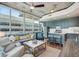 Bright living room boasts a modern kitchen, a cozy seating area, and large windows with an urban view at 777 N Ashley Dr # 915, Tampa, FL 33602